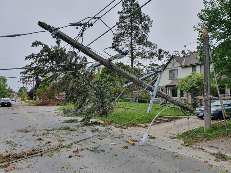 Outdoor photo of a fallen utility pole.