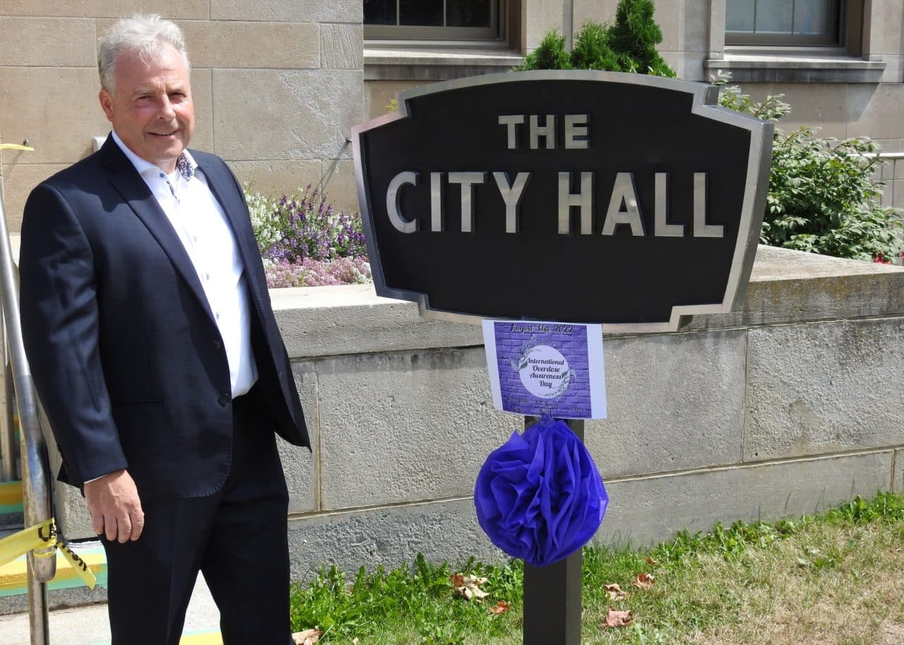 Photo of Brian Lumsden next to City Hall