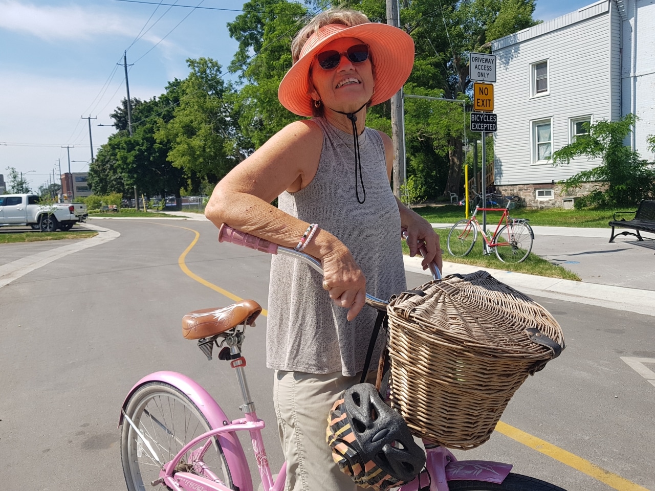 Photo shows cyclist Maggie O'Donnell standing with her bike between her legs on Bethune Street.