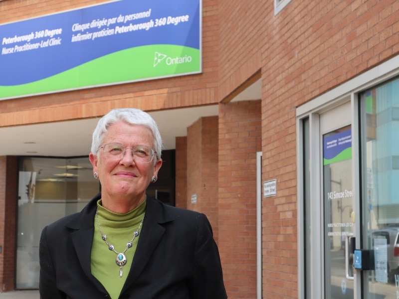 Photo shows Kirsten Woodend standing in front of the 360 Degree Nurse Practitioner-Led Clinic on Simcoe Street in downtown Peterborough.