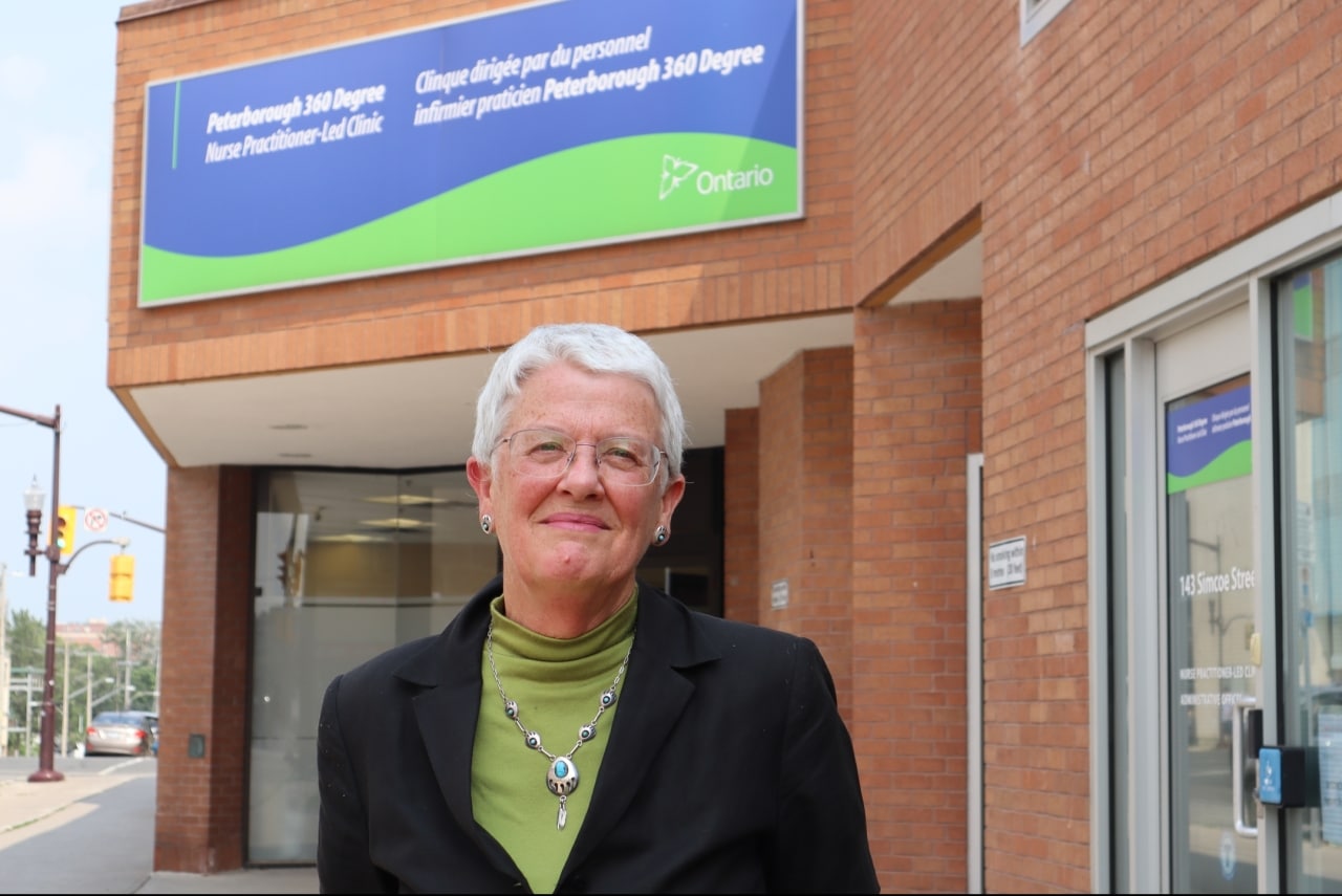 Photo shows Kirsten Woodend standing in front of the 360 Degree Nurse Practitioner-Led Clinic on Simcoe Street in downtown Peterborough.