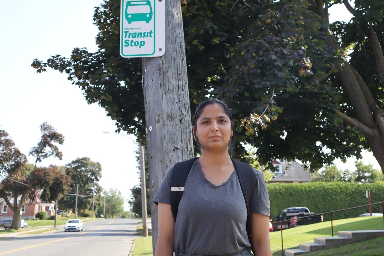 Raavi Shergill waits for a Peterborough Transit bus on Park Street on a sunny day in September.