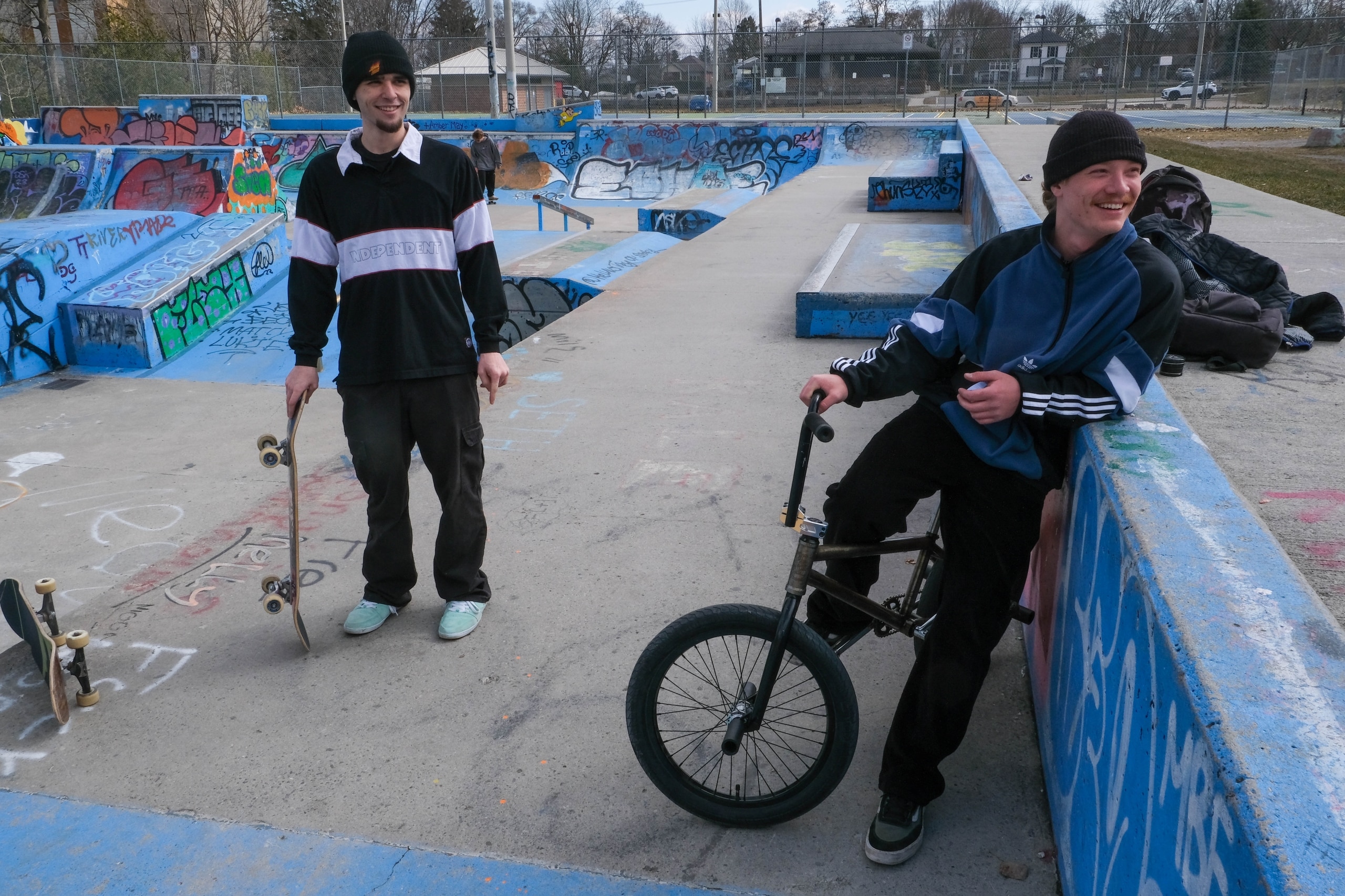 Photo shows a skateboarder and a cyclist hanging out at the skate park in Bonnerworth Park.